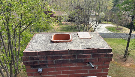 Chimney Before Crown Repair & Cap Installation Chimney showing structural damage and no chimney cap before repair and protection improvements.