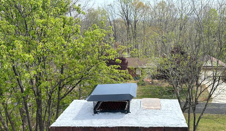 Completed chimney repair with damaged areas restored and new chimney cap installed for protection and improved safety.